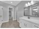Bright bathroom featuring a white vanity with a marble countertop and a framed mirror at 851 Klamath Springs St, Henderson, NV 89011