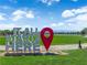 Community landmark sign with a walking path, water feature, and lush lawns at 851 Klamath Springs St, Henderson, NV 89011