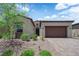 Inviting single-story home with a well-manicured front yard, desert landscaping and paved driveway at 851 Klamath Springs St, Henderson, NV 89011