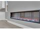 Close-up of the modern fireplace with decorative rocks and vibrant lighting at 851 Klamath Springs St, Henderson, NV 89011