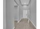 Clean and modern hallway with light gray walls, trim, and tile flooring at 851 Klamath Springs St, Henderson, NV 89011
