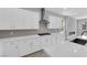 Well-appointed kitchen with gray backsplash, stainless hood, and white quartz countertops at 851 Klamath Springs St, Henderson, NV 89011