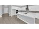 Bright kitchen features white cabinets, stainless appliances, an island and modern countertops at 851 Klamath Springs St, Henderson, NV 89011