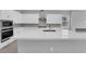 Modern kitchen featuring sleek countertops, stainless appliances, and a view of the fireplace at 851 Klamath Springs St, Henderson, NV 89011