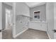 Practical laundry room with white cabinetry and a window, offering a functional space at 851 Klamath Springs St, Henderson, NV 89011