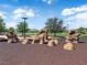 Community playground with rock climbing structure and lush greenery for active  at 851 Klamath Springs St, Henderson, NV 89011