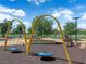 Playground with swings in a Gathering-friendly community setting, featuring lush landscaping at 851 Klamath Springs St, Henderson, NV 89011