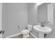Cozy powder room featuring a pedestal sink and a mirror, perfect for guests at 851 Klamath Springs St, Henderson, NV 89011