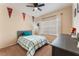 Cozy bedroom with a ceiling fan, ample natural light, and a view of the backyard at 8605 Trianon Ln, Las Vegas, NV 89145