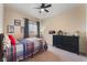 Comfortable bedroom features a ceiling fan and a large dresser for ample storage at 8605 Trianon Ln, Las Vegas, NV 89145