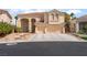 Charming two-story home with a tile roof and attached three-car garage, set in a desert landscape at 8605 Trianon Ln, Las Vegas, NV 89145