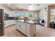 Spacious kitchen with granite countertop island, stainless steel appliances, tiled backsplash, and adjacent breakfast nook at 8605 Trianon Ln, Las Vegas, NV 89145