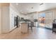 Bright kitchen features white cabinets, stainless steel appliances, and a granite countertop island with bar stool seating at 8605 Trianon Ln, Las Vegas, NV 89145