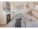 Bright living room with fireplace, soaring ceilings, large windows, and a staircase at 8605 Trianon Ln, Las Vegas, NV 89145