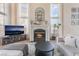 Warm and inviting living room featuring a fireplace, large windows, and modern decor at 8605 Trianon Ln, Las Vegas, NV 89145