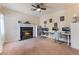 Spacious home office with a fireplace, ample desk space, and views of the surrounding landscape at 8605 Trianon Ln, Las Vegas, NV 89145