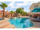 Sparkling pool and spa area with mature landscaping, lounge chairs, and patio umbrella at 8605 Trianon Ln, Las Vegas, NV 89145