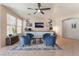 Cozy sitting room features blue armchairs, a ceiling fan, and stylish decor at 8605 Trianon Ln, Las Vegas, NV 89145