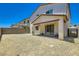 View of the house and gravel-covered backyard showcasing a sliding glass door and block wall, perfect for outdoor activities at 9440 Lunar Ray St, Las Vegas, NV 89143
