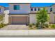 Inviting two-story home with a well-maintained front yard and a spacious garage at 9440 Lunar Ray St, Las Vegas, NV 89143