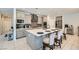 Modern kitchen boasting a large island, seating, and stainless steel appliances at 9440 Lunar Ray St, Las Vegas, NV 89143