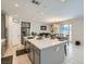 Spacious kitchen featuring an island with seating, stainless steel appliances, and tile flooring at 9440 Lunar Ray St, Las Vegas, NV 89143