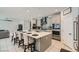 Open-concept kitchen with an island, stainless steel appliances, and breakfast bar seating at 9440 Lunar Ray St, Las Vegas, NV 89143