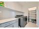 Functional laundry room featuring modern washer and dryer units, shelving, and ample storage space for convenience at 9440 Lunar Ray St, Las Vegas, NV 89143