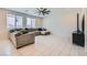 Inviting living room featuring a sectional sofa, large windows, and tile flooring at 9440 Lunar Ray St, Las Vegas, NV 89143