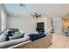 Open living room features tile flooring, a ceiling fan, and comfortable sofa seating with a large TV at 9440 Lunar Ray St, Las Vegas, NV 89143