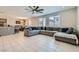 Open-concept living area features a large sectional sofa and tile floors at 9440 Lunar Ray St, Las Vegas, NV 89143