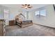 Spacious main bedroom features plush carpet, bright windows, and a decorative wooden bed frame at 9440 Lunar Ray St, Las Vegas, NV 89143