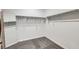 An empty walk-in closet with neutral carpet, a mirror, and a hanging rod at 9440 Lunar Ray St, Las Vegas, NV 89143