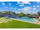 Aerial view of home featuring a pool, outdoor kitchen, luscious green lawn, and a sleek modern design at 9972 Terrastone Dr, Las Vegas, NV 89148