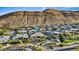 Beautiful neighborhood with mountain views, lush landscaping, and well-maintained homes with unique architectural features at 9972 Terrastone Dr, Las Vegas, NV 89148