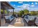 This backyard features a covered outdoor kitchen, cozy fire pit, seating areas and pool at 9972 Terrastone Dr, Las Vegas, NV 89148