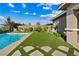 Enjoy outdoor living with a pool, playground, and lounge area on a well-manicured lawn at 9972 Terrastone Dr, Las Vegas, NV 89148
