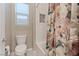 Bathtub features white subway tile, a floral shower curtain, and a convenient built-in niche at 9972 Terrastone Dr, Las Vegas, NV 89148