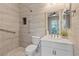 Modern bathroom with tiled walls, a walk-in shower with grab bars, and a vanity with a stylish gold faucet at 9972 Terrastone Dr, Las Vegas, NV 89148