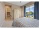 Comfortable bedroom with sliding glass door to an outdoor pool area and connected closets at 9972 Terrastone Dr, Las Vegas, NV 89148