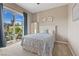 Cozy bedroom featuring a sliding glass door to the patio with a serene outdoor view and swing at 9972 Terrastone Dr, Las Vegas, NV 89148