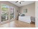 Bright bedroom with large windows offering beautiful views, features a white daybed with storage drawers and light wood floors at 9972 Terrastone Dr, Las Vegas, NV 89148