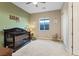 Cozy Bedroom featuring a dark wood crib, soft carpet, and ample natural light at 9972 Terrastone Dr, Las Vegas, NV 89148