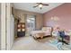 Bedroom with a full size bed, desk, and a colorful wall decoration at 9972 Terrastone Dr, Las Vegas, NV 89148