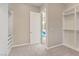 Spacious closet with neutral walls and an open doorway leading to a glimpse of a bathroom with a vanity at 9972 Terrastone Dr, Las Vegas, NV 89148