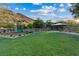Scenic community park featuring a playground, green space, picnic pavilion, and walking paths with mountain views at 9972 Terrastone Dr, Las Vegas, NV 89148
