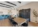 Elegant dining room with a long wooden table, black chairs, and a large built-in cabinet for ample storage at 9972 Terrastone Dr, Las Vegas, NV 89148