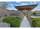 Inviting entrance to Onyx Point community featuring stone architecture, mature landscaping, and a welcoming walkway at 9972 Terrastone Dr, Las Vegas, NV 89148