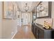 Bright entryway with hardwood floors, elegant lighting, decorative console table, and modern artwork at 9972 Terrastone Dr, Las Vegas, NV 89148