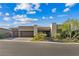 Attractive one-story home featuring a three-car garage, stone accents, desert landscaping and inviting curb appeal at 9972 Terrastone Dr, Las Vegas, NV 89148